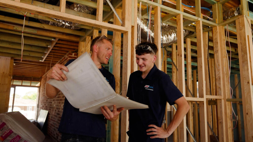 Zayde and Micko looking at plans
