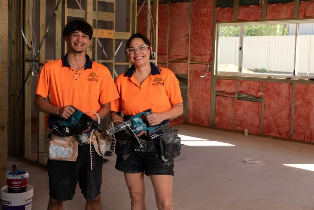 Kiriana with an apprentice holding power tools